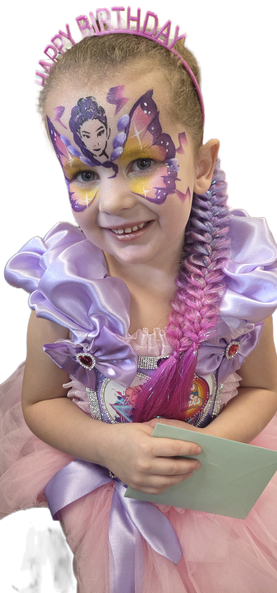 A girl with a vibrant jaguar face paint, wearing a pink floral outfit, poses excitedly against a bright, colorful backdrop, exuding joy.